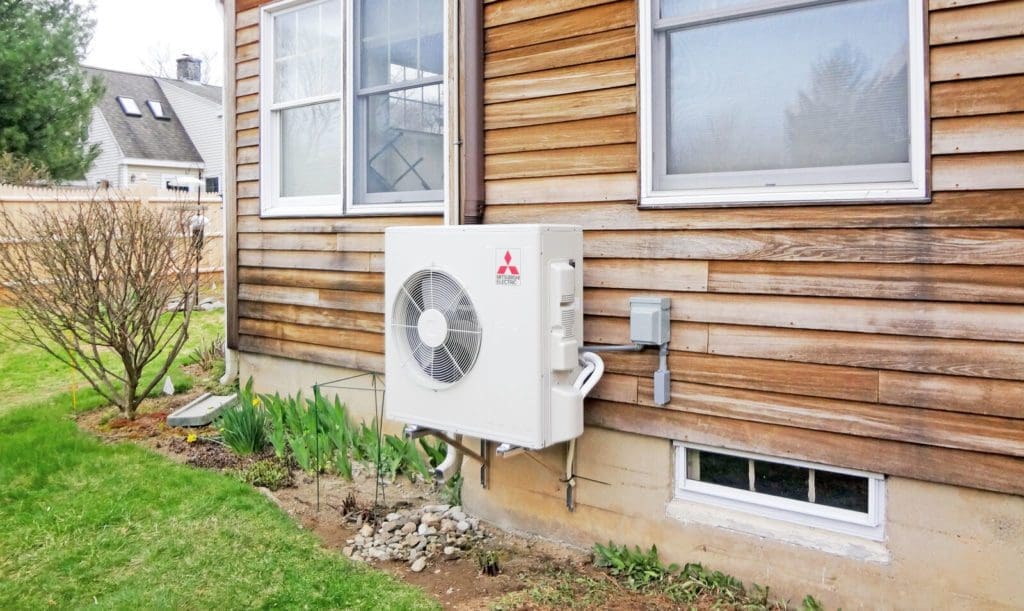 A newly installed Mitsubishi heat pump is attached to a Chicago home.