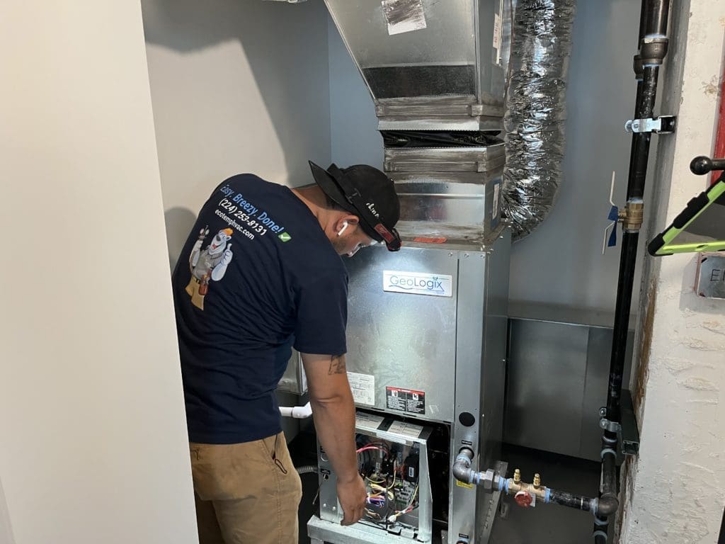 HVAC technician repairing a broken furnace in Highland Park IL.